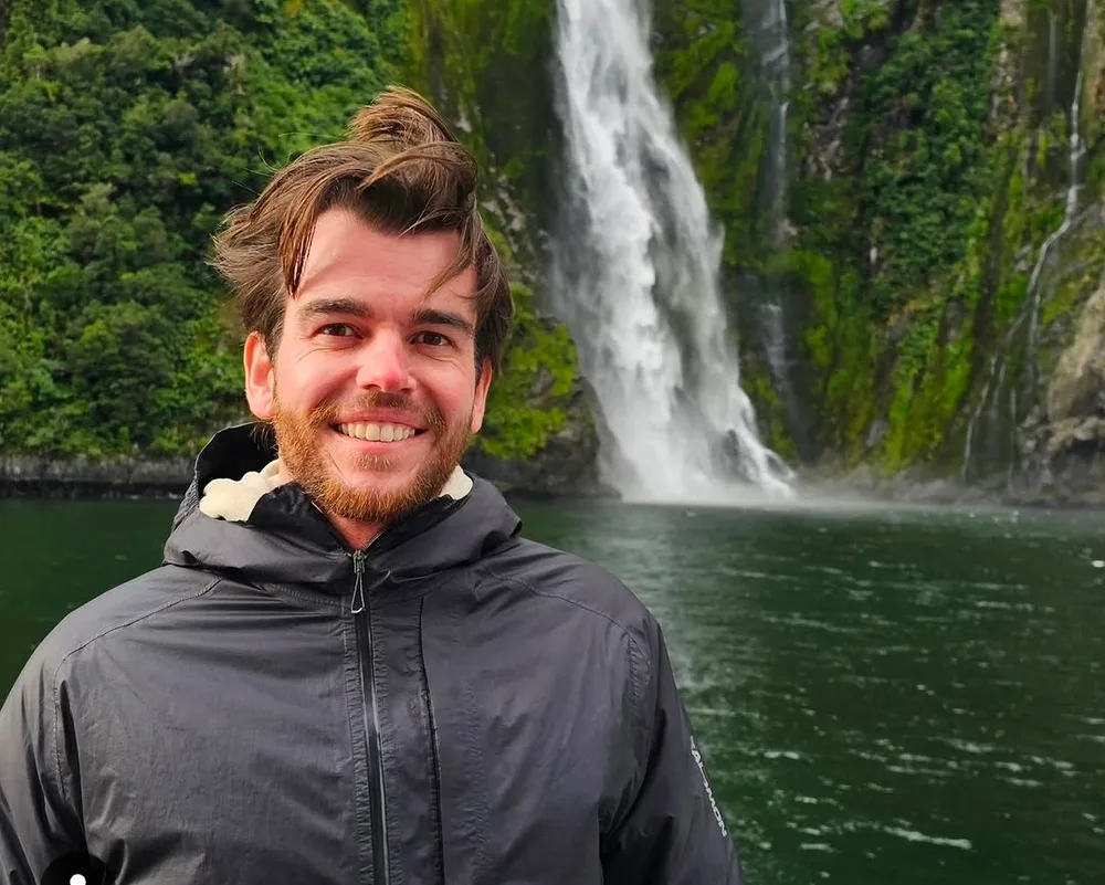 Vaughn Littlejohns in front of a waterfall